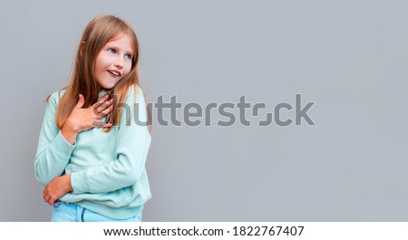 Portrait with copyspace empty place of shocked impressed girl with wide open mouth looking at camera isolated on gray background