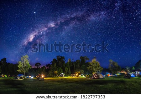 Tourist tent area on the mountain  at night in the sky with the Milky Way, Long exposure photograph, with grain.Image contain certain grain or noise and soft focus.