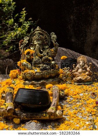 Altar with statue of Indian god Ganesh With Flower , Thailand