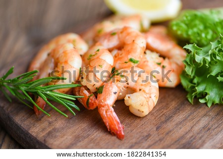 Salad shrimp grilled delicious seasoning spices on wooden cutting board background appetizing cooked shrimps baked prawns , Seafood shelfish with rosemary lemon and lettuce Royalty-Free Stock Photo #1822841354