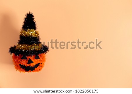 Halloween background with glitter pumpkin character decor on color background.