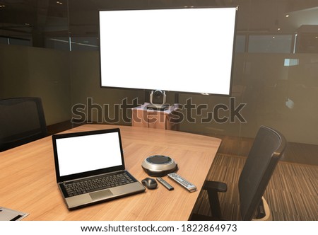 Mock up television and laptop with Clipping path on table in Video conference meeting room