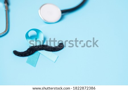 November Prostate Cancer Awareness, light Blue Ribbon with stethoscope and mustache for supporting people living and illness. Men Healthcare, International men and World cancer day concept