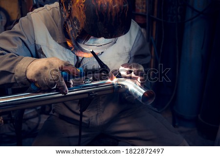 TIG welding of polished stainless steel pipe Royalty-Free Stock Photo #1822872497
