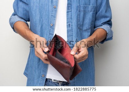 Man hand holding empty wallet on white background