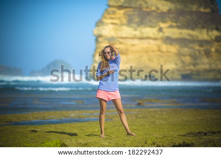woman walks alone on a green reef