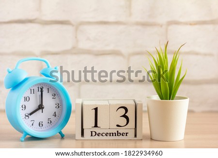 December 13 on the wooden calendar next to the alarm clock, the first day of the first winter month.