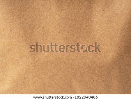 Brown paper bag close up. Texture of the paper bag as a background.
