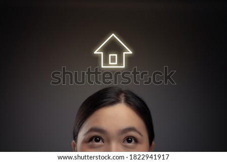 Happy Asian woman and home icon hologram effect. Isolated on background.