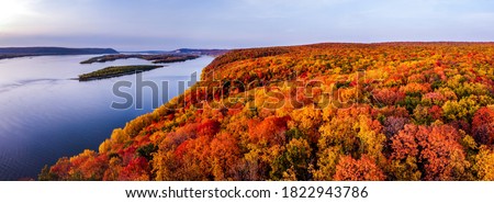 Aerial panoramic landscape view on Volga river with small sand islands and colorful forest on hills during autumn sunset, Samara, Russia Royalty-Free Stock Photo #1822943786