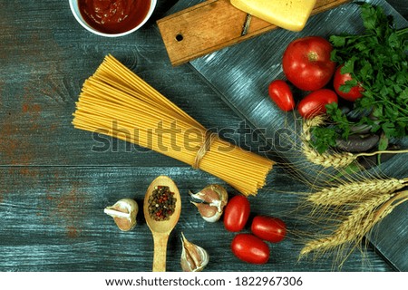 Ingredients for cooking spaghetti on a wooden table , top view . Traditional Italian cuisine .