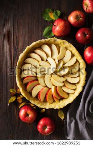 Autumn and summer pie with apple and plum on dark  background. Thanksgiving day table, copy space, top view, flat lay, vertical
