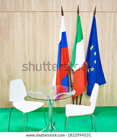 Flags of Russia, Italy and the European Union and table chairs