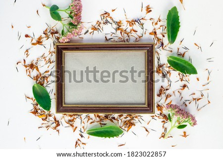 empty wooden frame with decoration with fresh and dry flowers, top view, gift