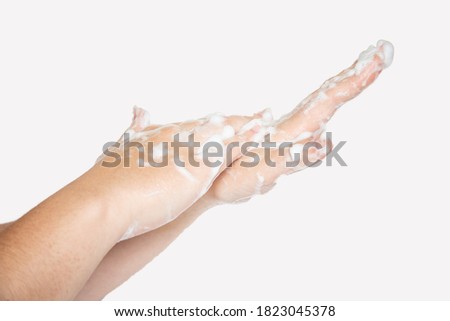 Woman hands isolated on white background. Washing hands with soap bubbles.