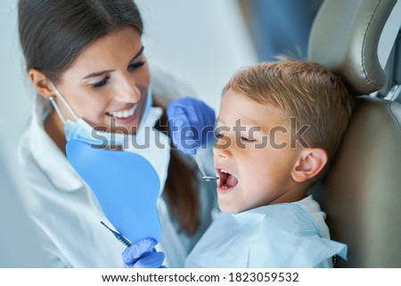 Little boy and female dentist in the dentists office