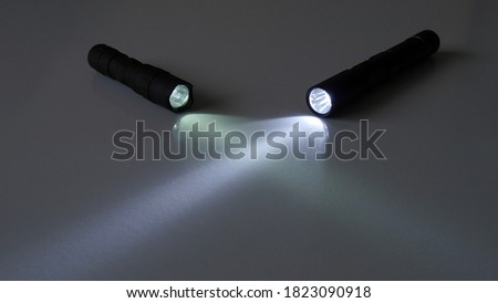 Two LED flashlights on dark background
