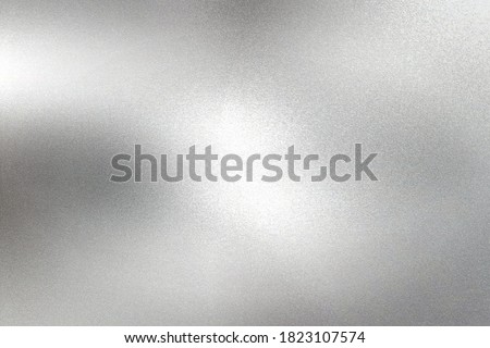 Glowing silver foil paper wall with copy space, abstract texture background
