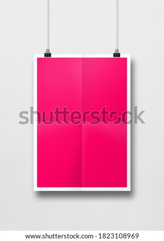 Pink folded poster hanging on a white wall with clips. Blank mockup template. 3D illustration