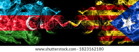 Azerbaijan, Azerbaijani vs Catalonia, Spain smoky mystic flags placed side by side. Thick colored silky abstract smoke flags
