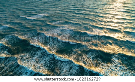 Aerial view waves on sand beach. Sea waves on the beautiful beach aerial view drone shot.