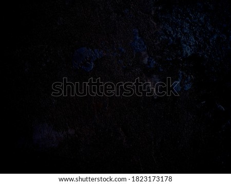 Abstract black background. The surface is rough and dark.