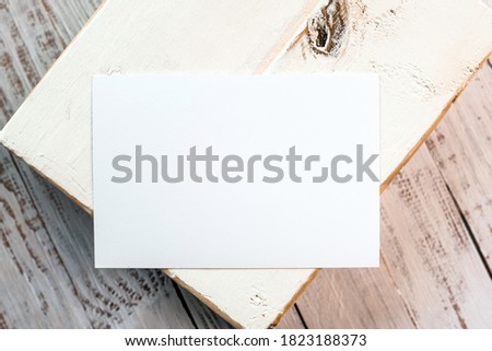 Photo of blank white card on a wooden block. Blank template for brand identity mock-up design, food theme. Presentation and portfolio template