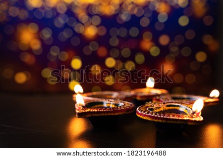 Indian festival Diwali, Diya oil lamps lit on colorful rangoli. Hindu traditional. Happy Deepavali. Copy space for text. Royalty-Free Stock Photo #1823196488