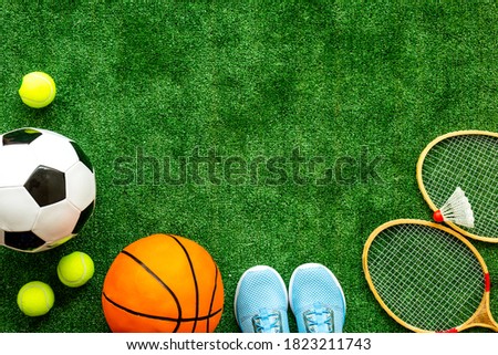 Flat lay of sport balls - football, basketball on grass top view copy space Royalty-Free Stock Photo #1823211743