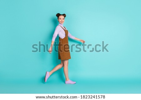 Full body profile photo of pretty amazing nice beaming two buns hairstyle lady person walk autumn street park wear brown velvet dress purple sneakers sweater isolated teal color background