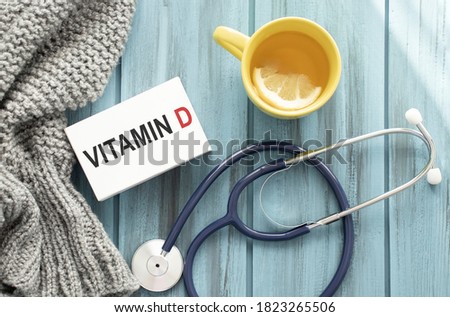 Vitamin D written on a paper on table, top view
