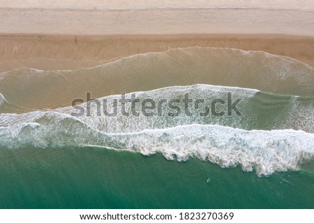 The cold water of the Atlantic Ocean washes onto a scenic beach on Cape Cod, Massachusetts. This beautiful peninsula is a popular summer vacation destination in New England.