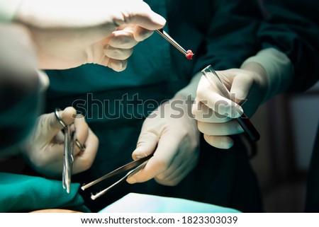 Medical surgery for removal the tissue of biopsy surgery will sent to pathology department. Surgical removal of pre-cancerous tissue in operating room.  Royalty-Free Stock Photo #1823303039