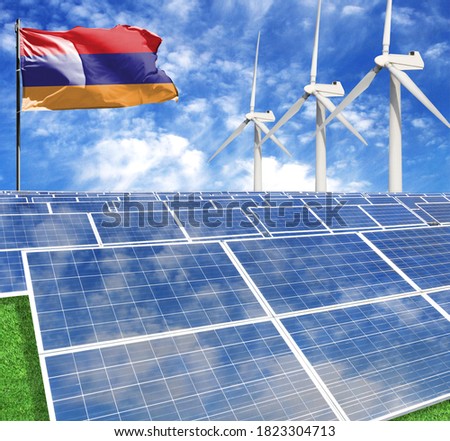 Solar panels on the background of a flagpole with the flag of Armenia and Wind Turbine