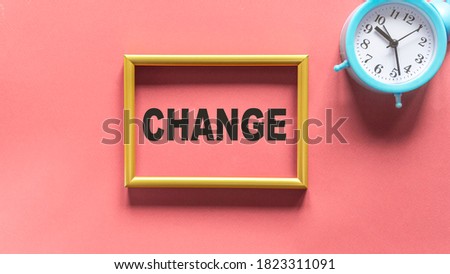 Chance, the text is written in a gold frame on a red background and a blue alarm clock