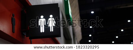 Restroom sign label on a symbol of a public toilet. copy space banner. 