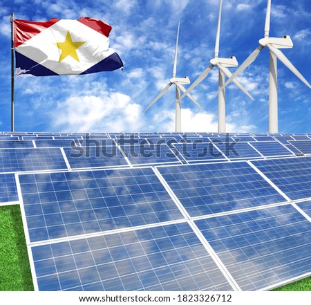 Solar panels on the background of a flagpole with the flag of Saba and Wind Turbine