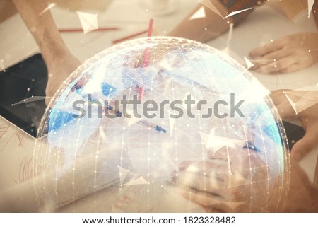 Double exposure of business theme drawing and man and woman working together holding and using a mobile device.