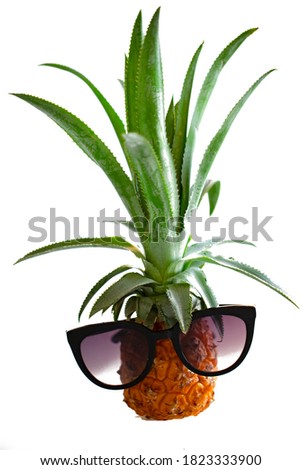 Pineapple with sunglasses, isolated on white.