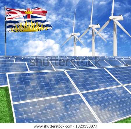 Solar panels on the background of a flagpole with the flag of British Columbia and Wind Turbine