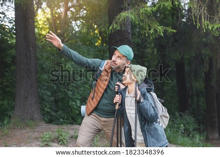 Portrait of happy father and son taking selfie while hiking together and walking in forest, copy space