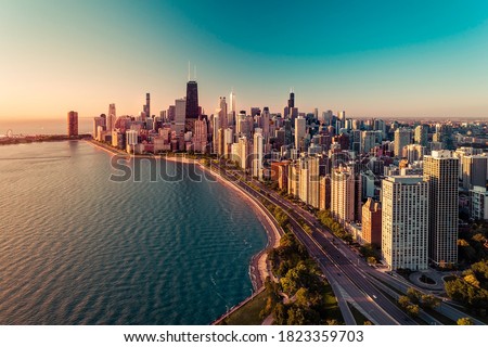 Chicago skyline aerial view with  sunrise above downtown buildings and Lake Michigan. Light effect applied. Royalty-Free Stock Photo #1823359703