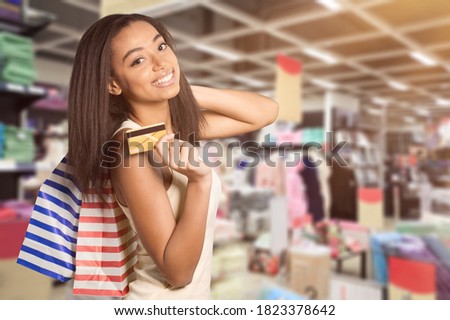 Young beautiful woman smiling holding credit card Royalty-Free Stock Photo #1823378642