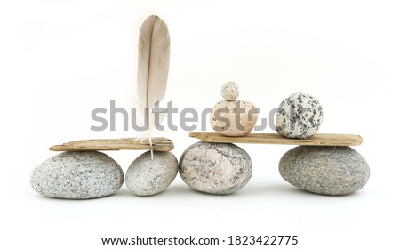 Sea smooth oval pebbles, driftwood and feather isolated on white background. Sea beach theme decorations. Coastal composition of small nature details.