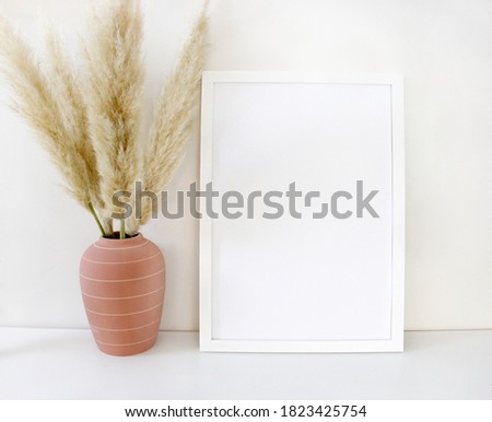 White frame mock up with pampas grass in a pink clay vase