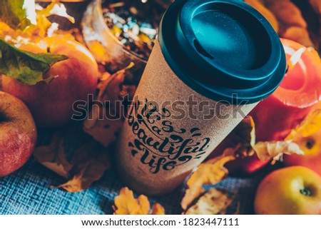 Autumn picture with yellow leaves and a glass of coffee
