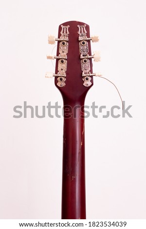 Guitar headstock back on a white background. Close plan. Wooden guitar.