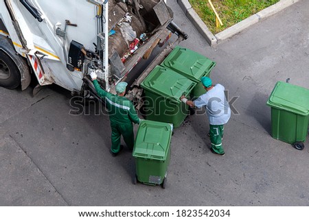 garbage men loading household rubbish in garbage truck, view from above Royalty-Free Stock Photo #1823542034