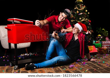 Friends after the Christmas party.  Young men take a picture. Concept of Christmas.