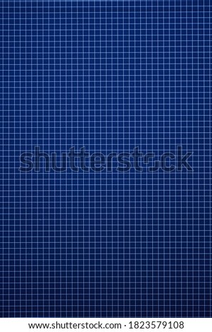 A studio photo of a blue grid background